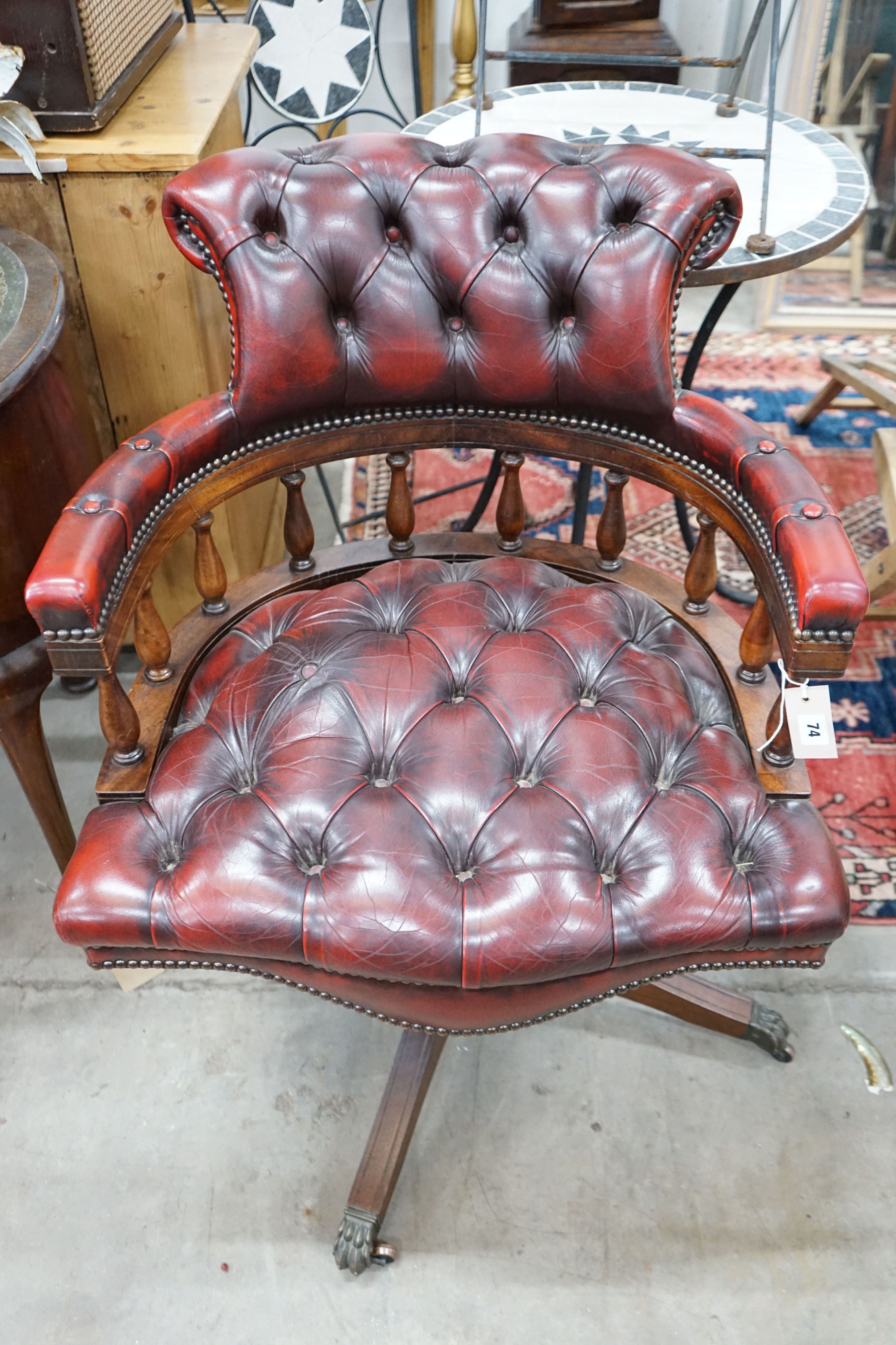 A reproduction Victorian style buttoned red leather upholstered swivel desk chair, width 63cm, depth 59cm, height 84cm